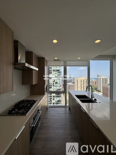 A modern kitchen with wooden cabinets and a large window overlooking the city.