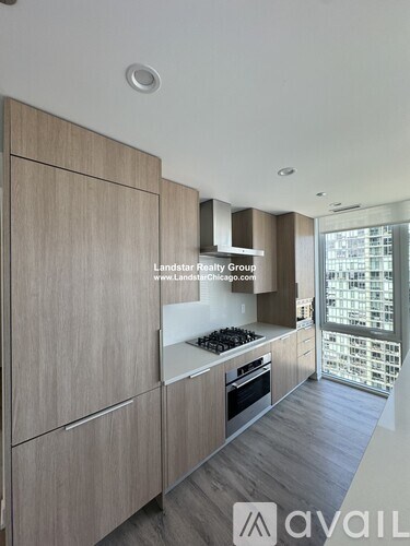 A modern kitchen with wooden cabinets and a stove top oven.