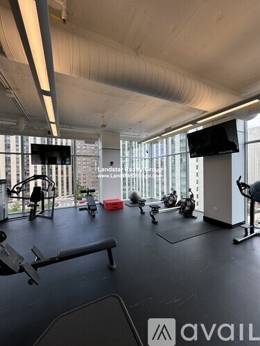 A gym with a variety of equipment including treadmills, stationary bikes, and weight machines.