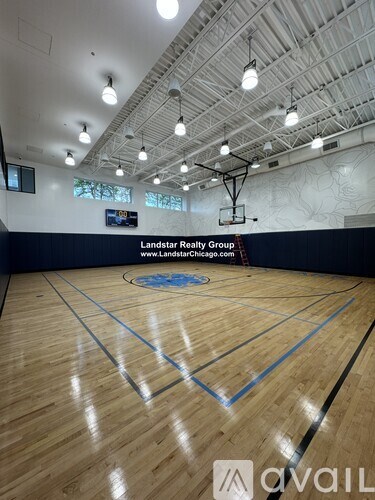 A basketball court with a logo of Landstar Realty Group on the wall.