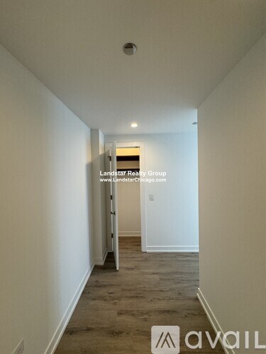 A long hallway with Landstar Realty Group logo and website on the wall.