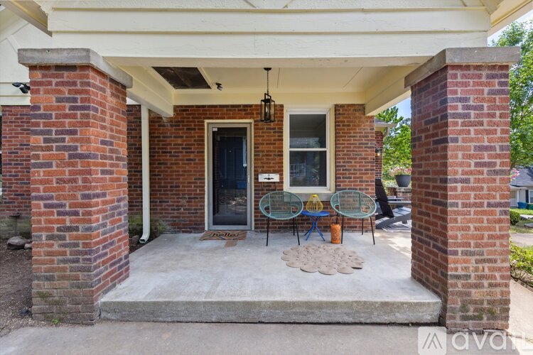 A house entrance with a black door and a glass window.