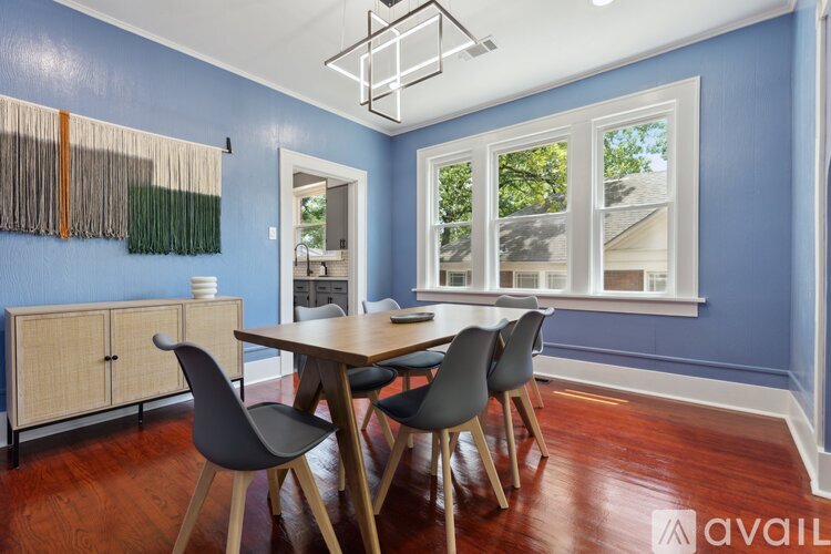 A dining room with a table and chairs.