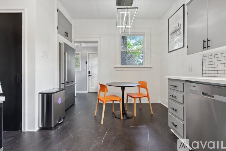 A kitchen with a table and chairs in the middle of the room.