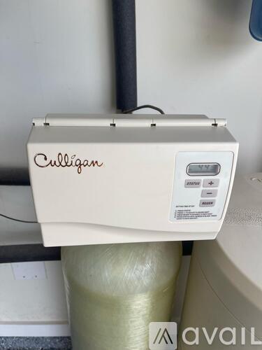 A Culligan water filtration system is installed on a wall.
