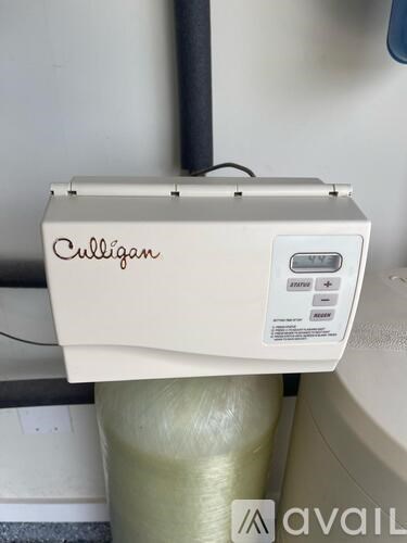 A Culligan water filtration system is installed on a wall.