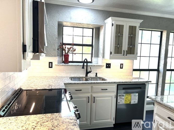 A kitchen with a granite countertop and a sink.