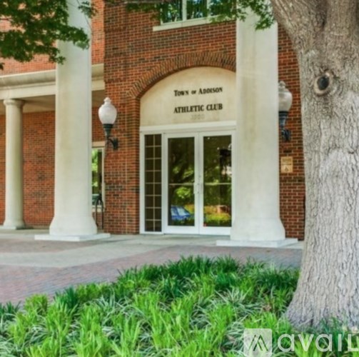 A brick building with a sign that says "Town & Addison Athletic Club.".