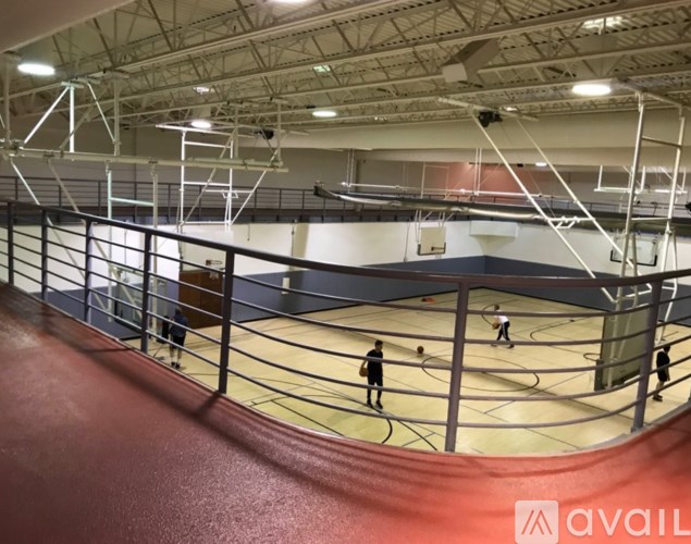 A basketball court with players in action and a logo that reads "AVAIL".