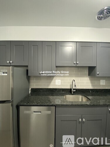 A kitchen with Landstar Realty Group sign on the wall.