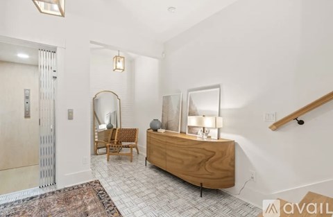 A bedroom with a wooden dresser and a mirror.