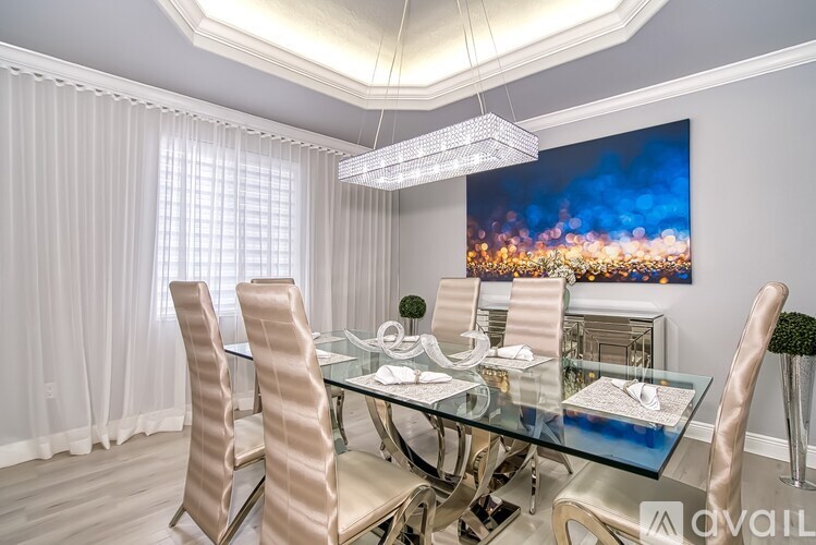 A dining room with a glass table and chairs.