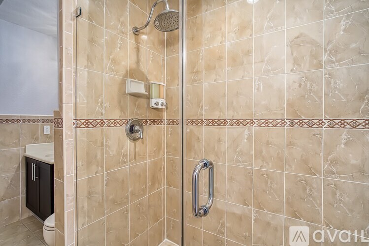 A bathroom with a tiled shower and a toilet.