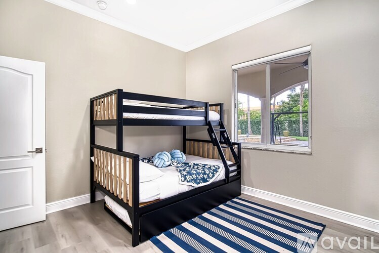 A bedroom with a bunk bed and a striped rug.