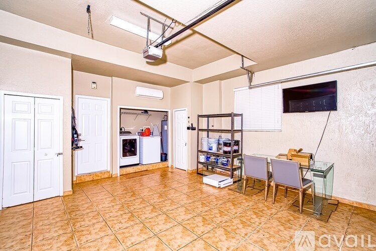 A living room with a television, a bookshelf, and a dining table.