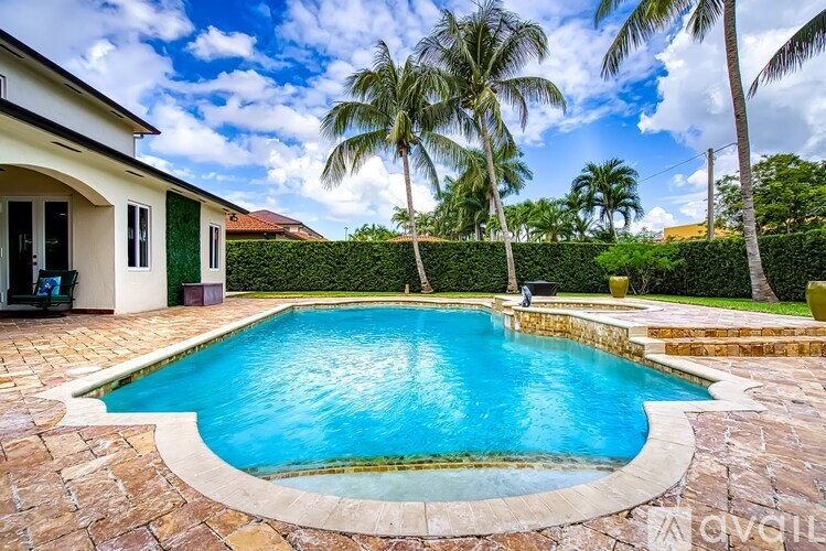 A swimming pool surrounded by a stone border.