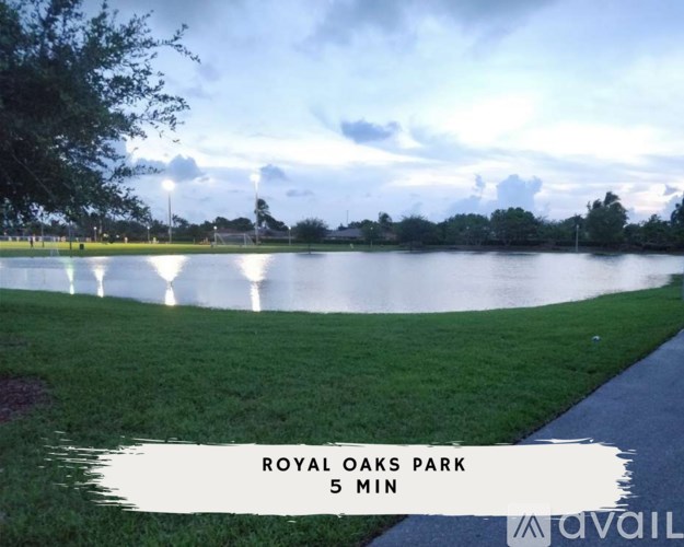 A park with a lake and a walking path.