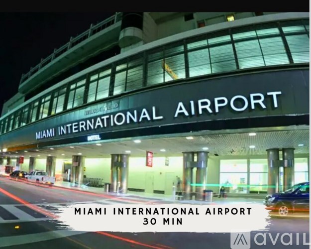 A sign for Miami International Airport is displayed in front of a building.