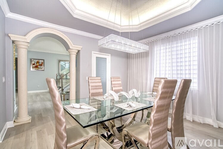 A dining room with a glass table and chairs.