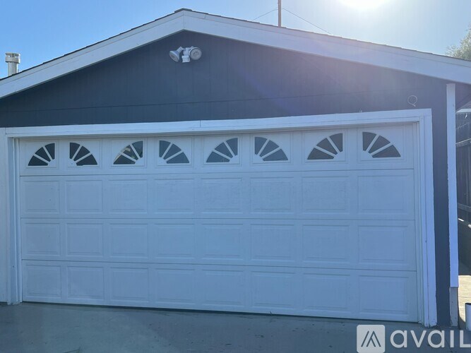A white garage door is closed.