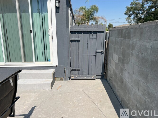 A grey metal gate is closed and locked.