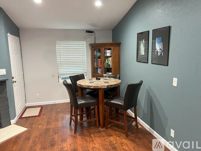 A dining room with a table and chairs.