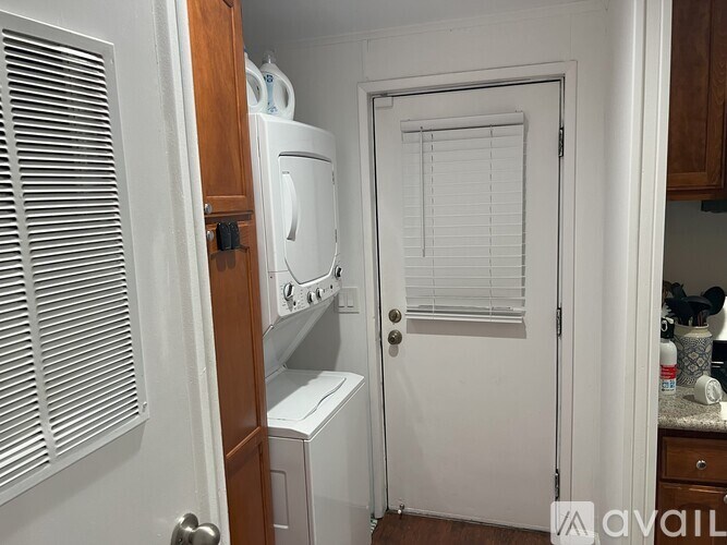 A small kitchen with a washing machine and a dryer.