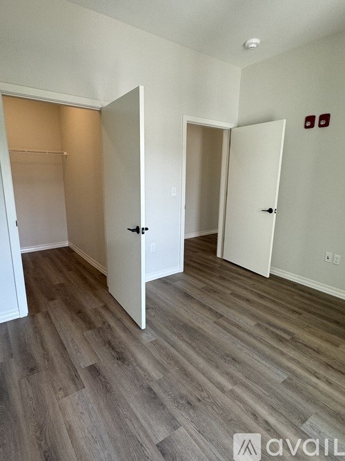 A room with two doors and a wooden floor.