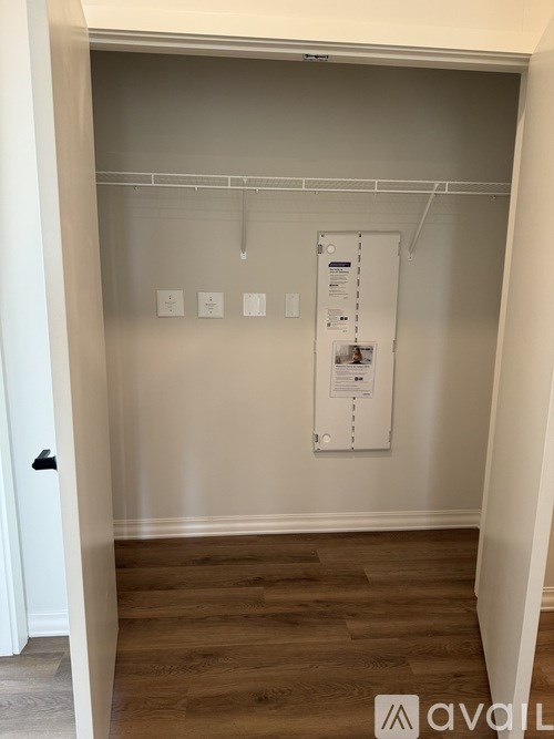 A white closet with a white door and a white hanger.