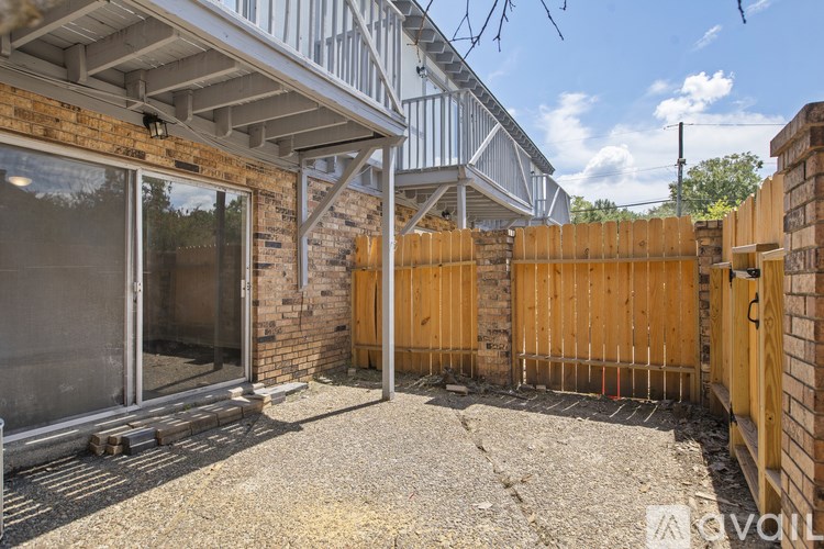 A backyard with a wooden fence and a patio area.