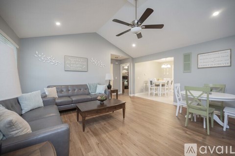 A living room with a grey couch and a wooden coffee table.