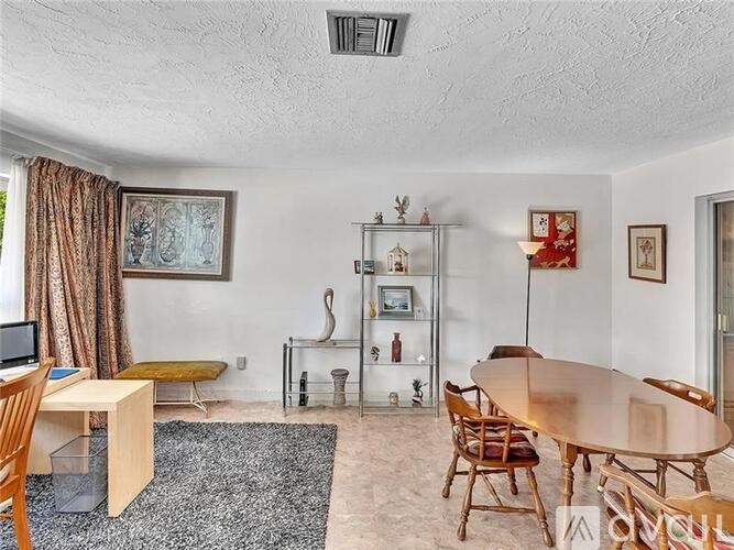 A dining room with a table and chairs.