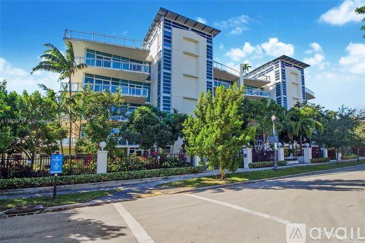 A modern building with a blue sign in front of it.