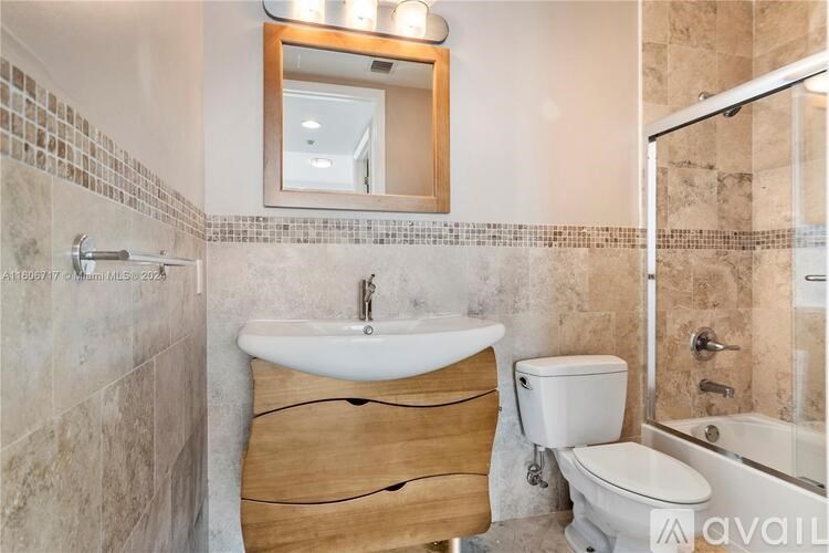 A bathroom with a sink, toilet, and bathtub.