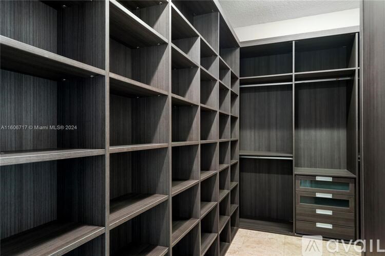 A room with a wall of shelves and drawers.