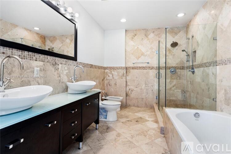 A bathroom with a sink, toilet, and bathtub.