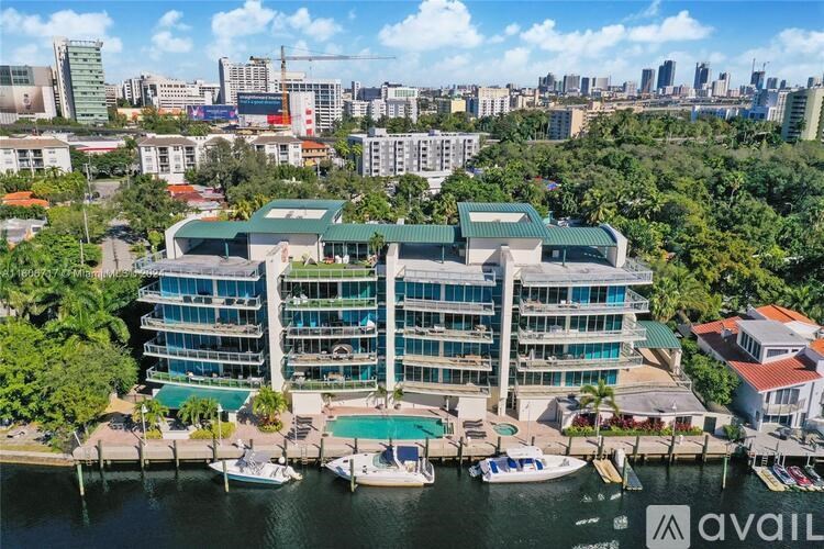 A large building with a pool in front of it.
