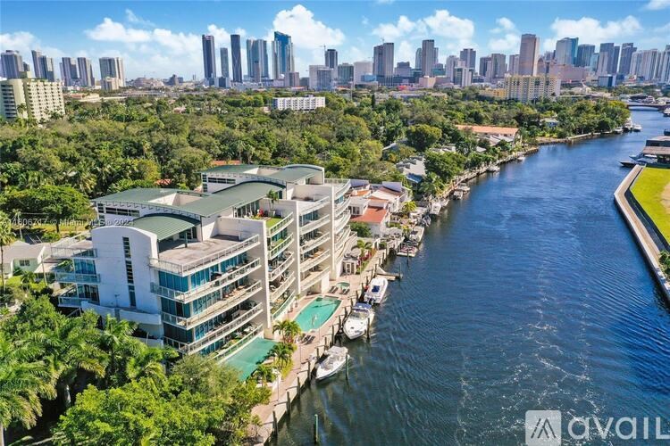 A river flows through a city with a building on the left.