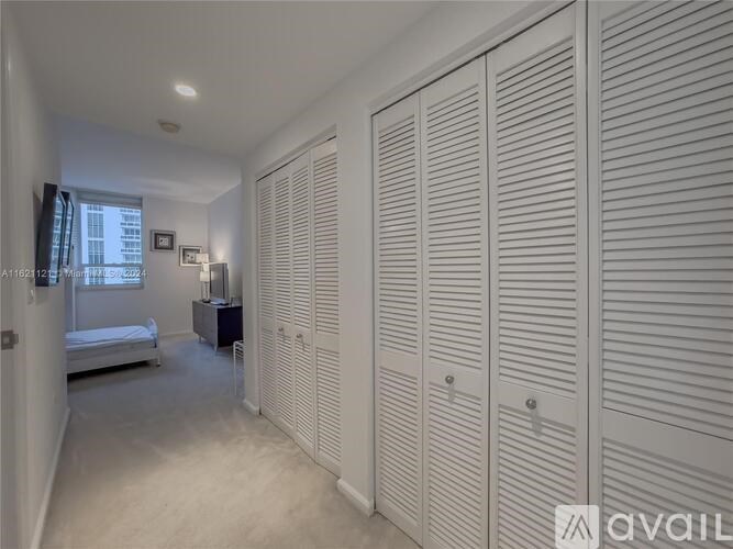 Closet with white doors in a bedroom.