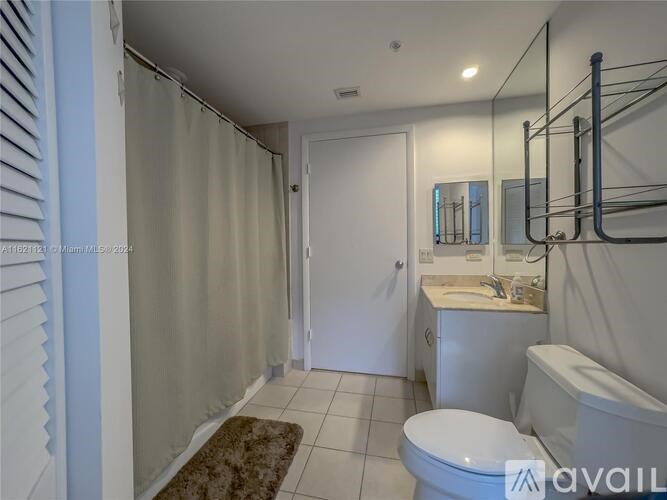 A bathroom with a toilet, sink, and bathtub.