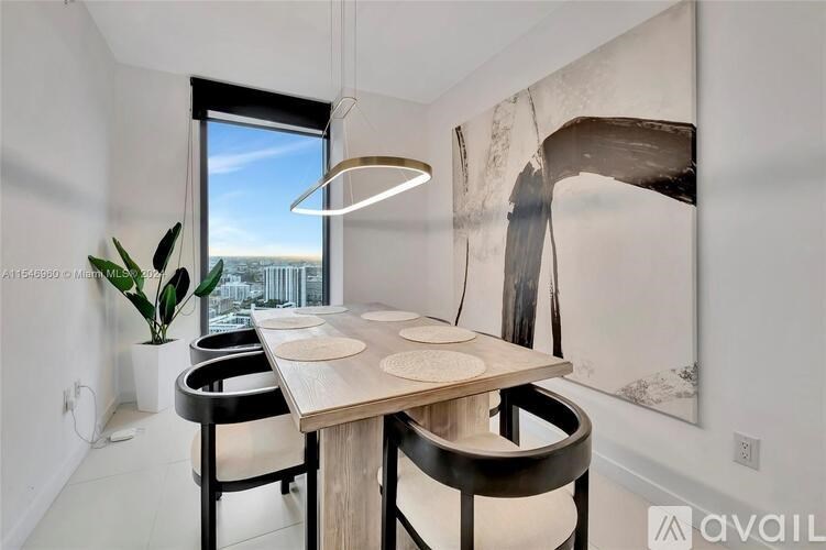 A modern dining room with a wooden table and chairs.