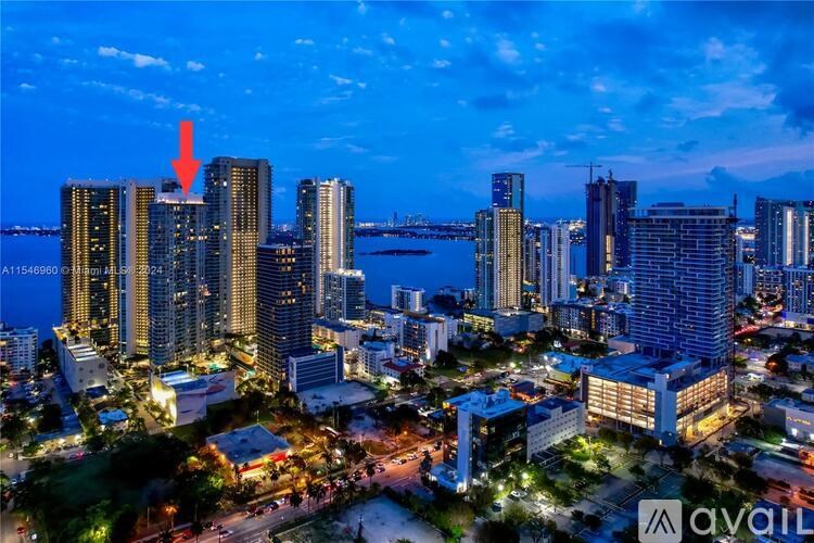 A red arrow points to a building in a cityscape at dusk.