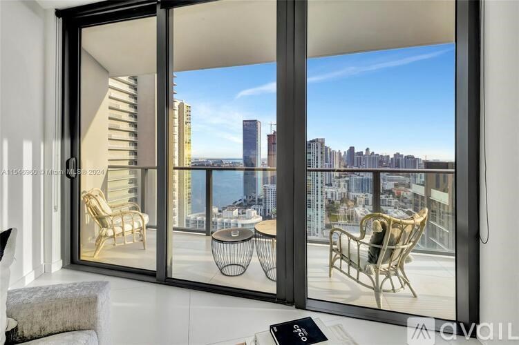 A living room with a view of the city skyline.