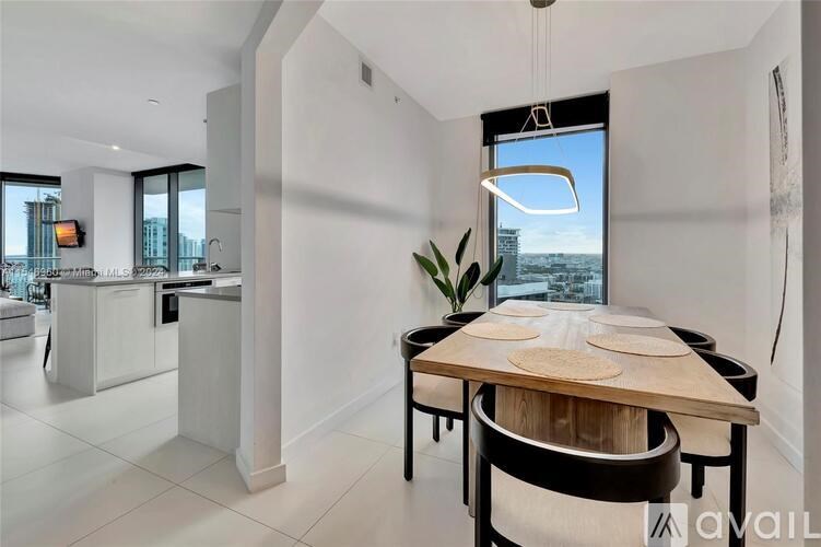 A modern kitchen with a dining table and chairs.