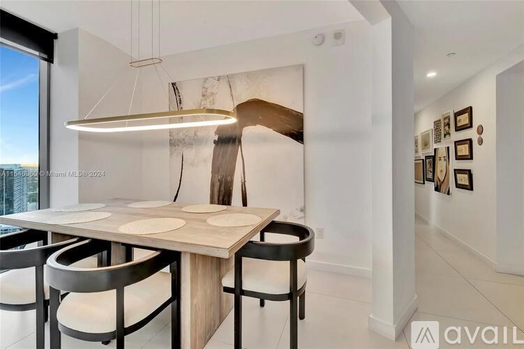 A modern dining room with a wooden table and chairs.