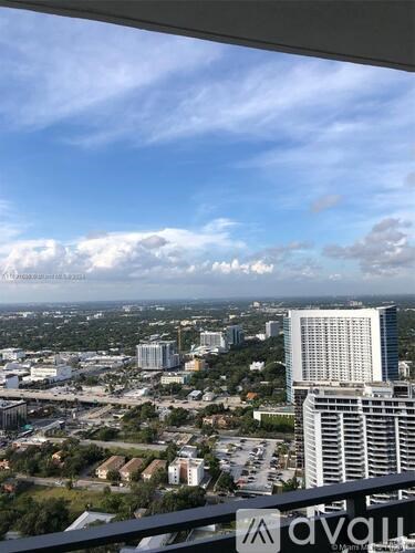 A cityscape with a clear sky and clouds.