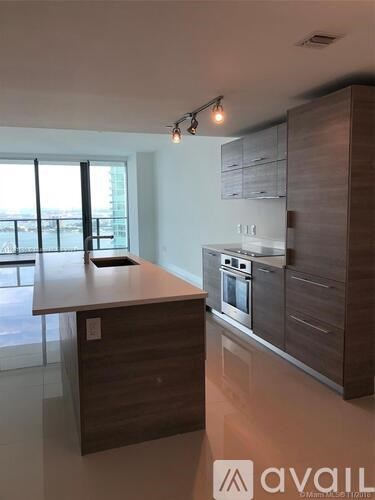 A modern kitchen with dark wood cabinets and a stainless steel oven.