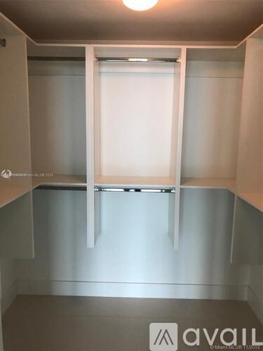 A white door with a glass window is in the middle of a room.