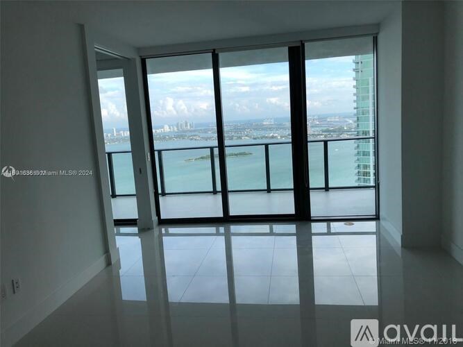 A large window with a view of the cityscape and water.