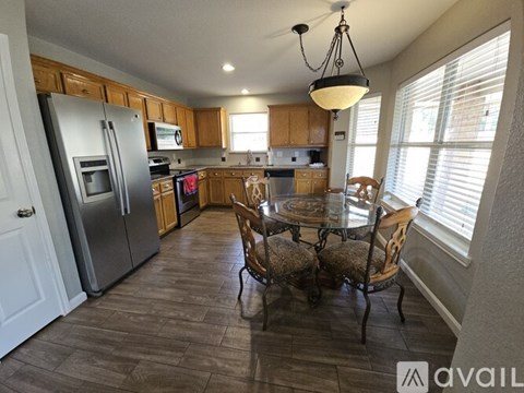 A kitchen with a table and chairs in the middle of the room.